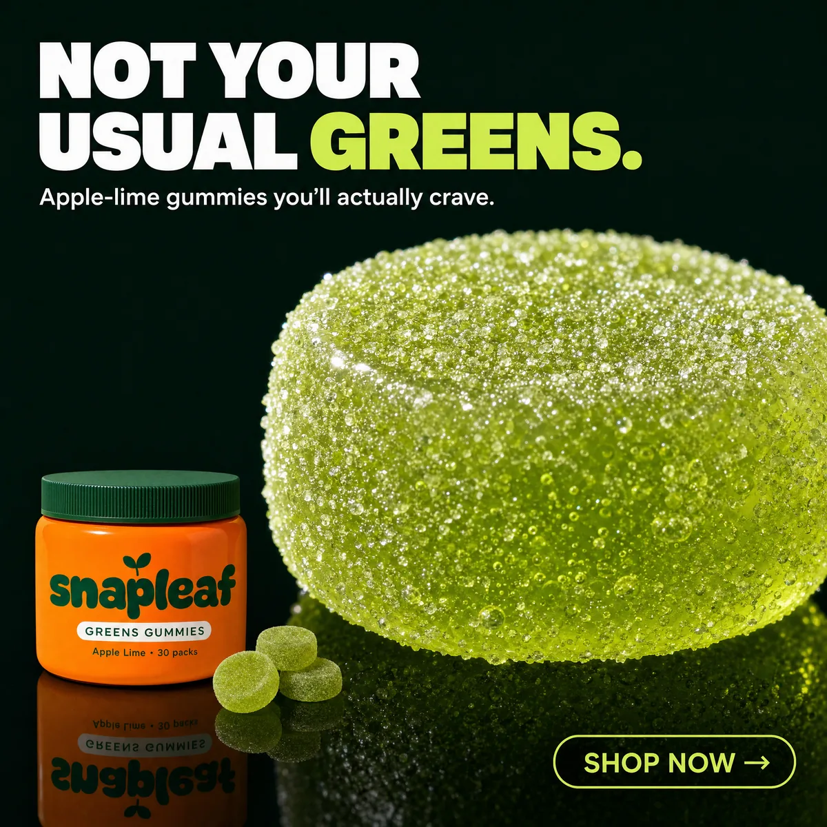 A giant sugar-crusted lime-green gummy glows on a black mirror floor next to a small orange Snapleaf tub.